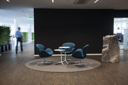 brown circular felt rug with seating in high traffic area