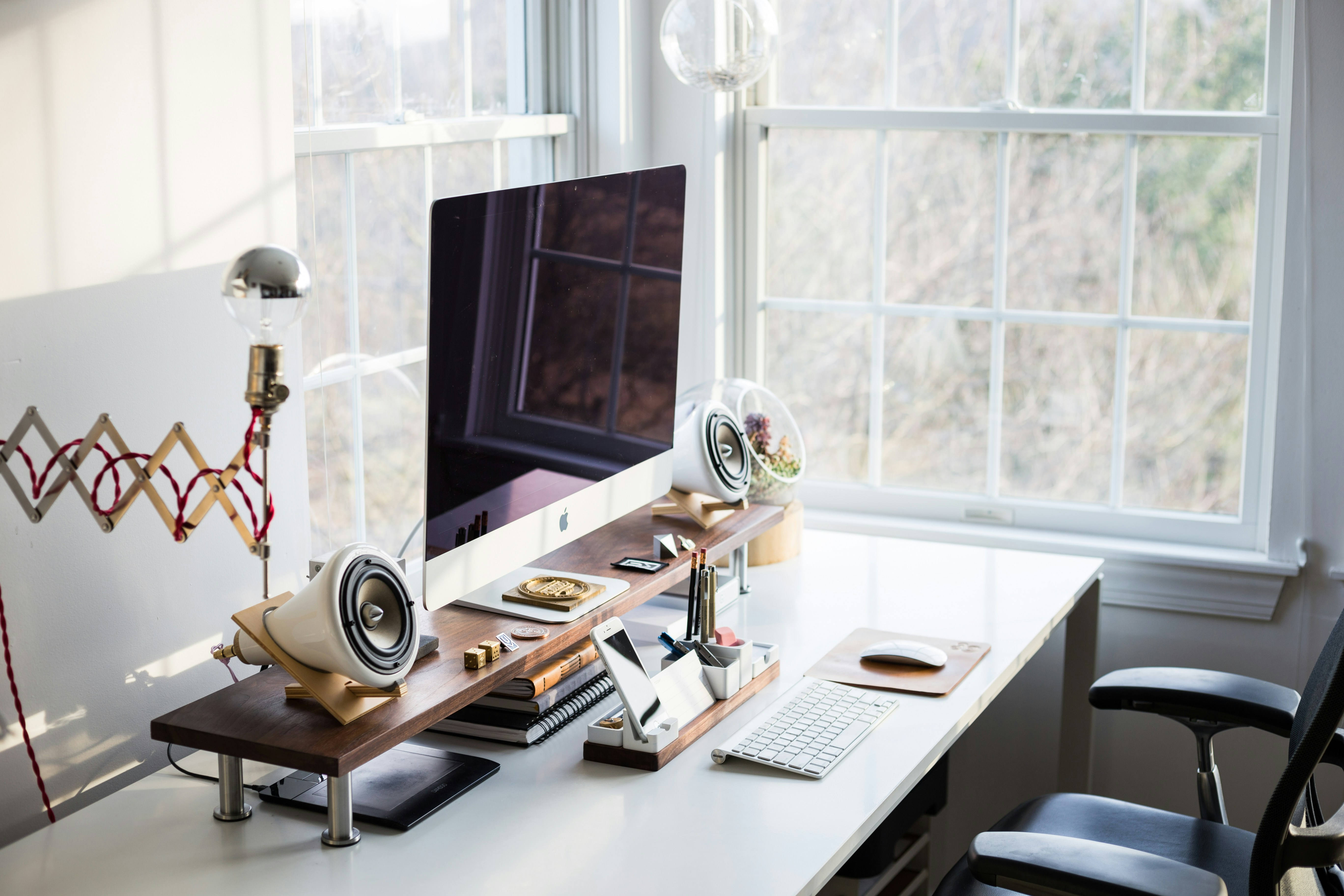 home office desk with computer and books