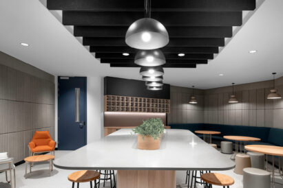 banner baffle above table with ecoustic neilson tiles installed on walls with banquette seating