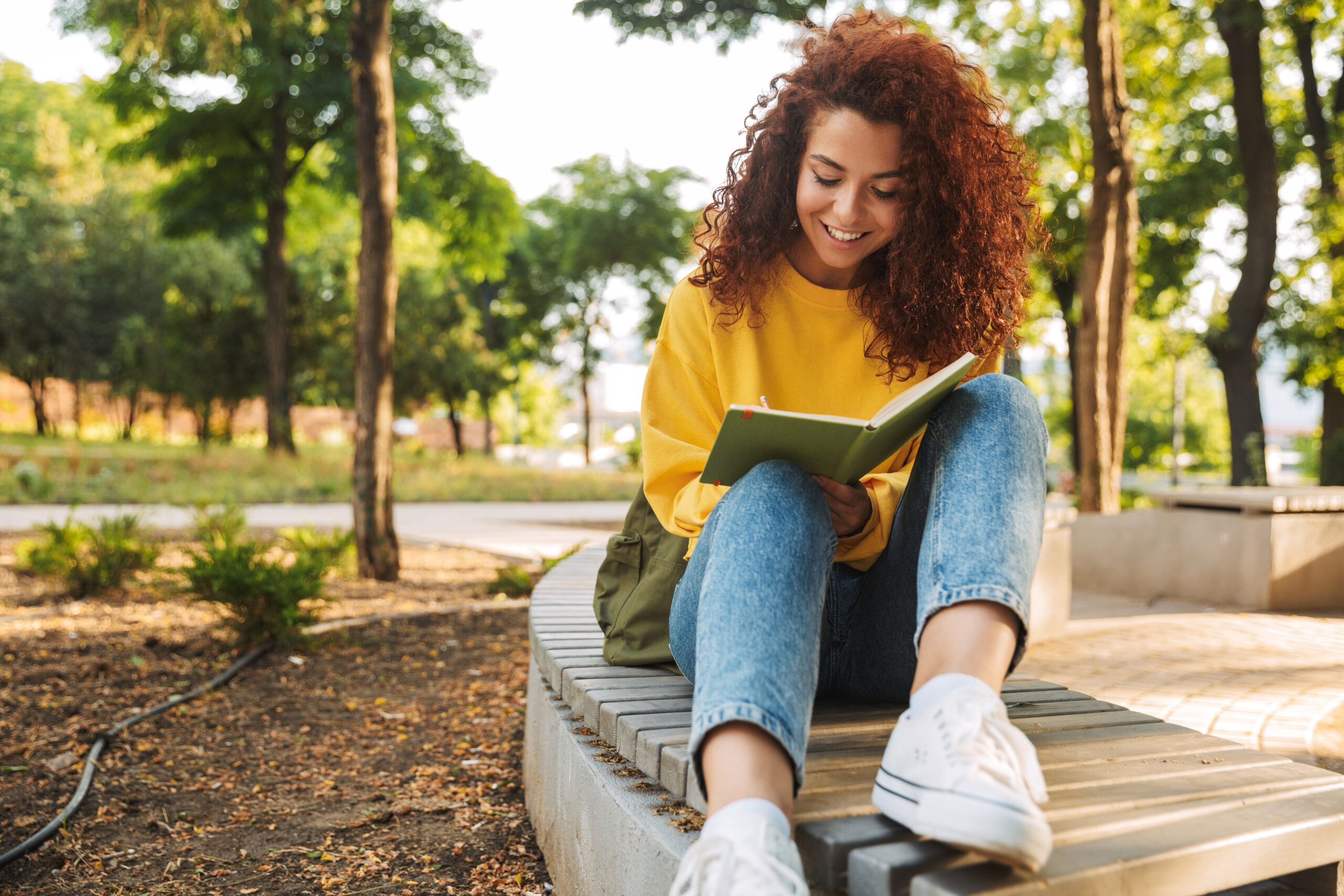 College student writing in notebook