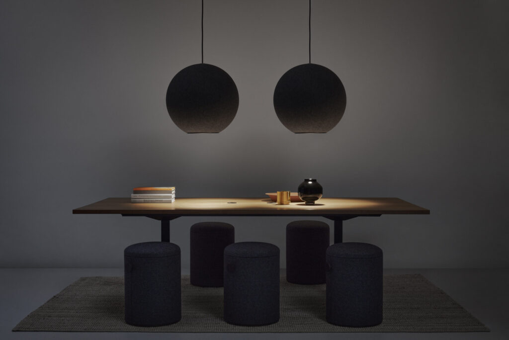 two globe shaped acoustic lamps above wooden table in dark room