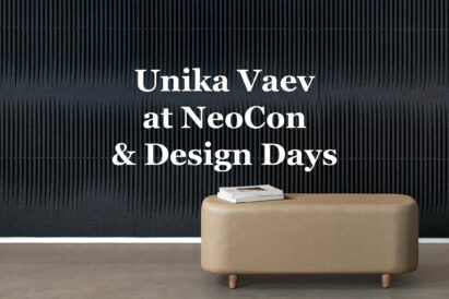 dark blue woven acoustic tile with white text overlaid behind tan ottoman