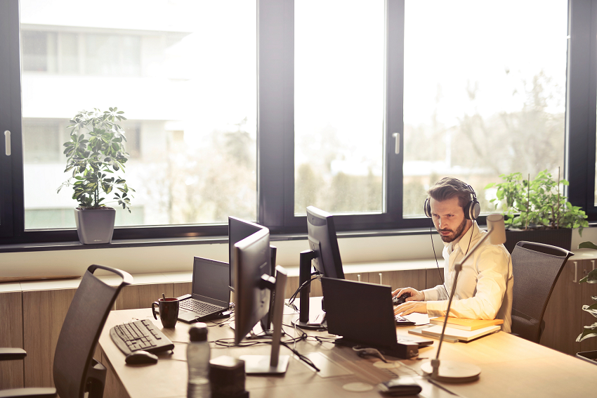 Man Working on Computer With Headphones