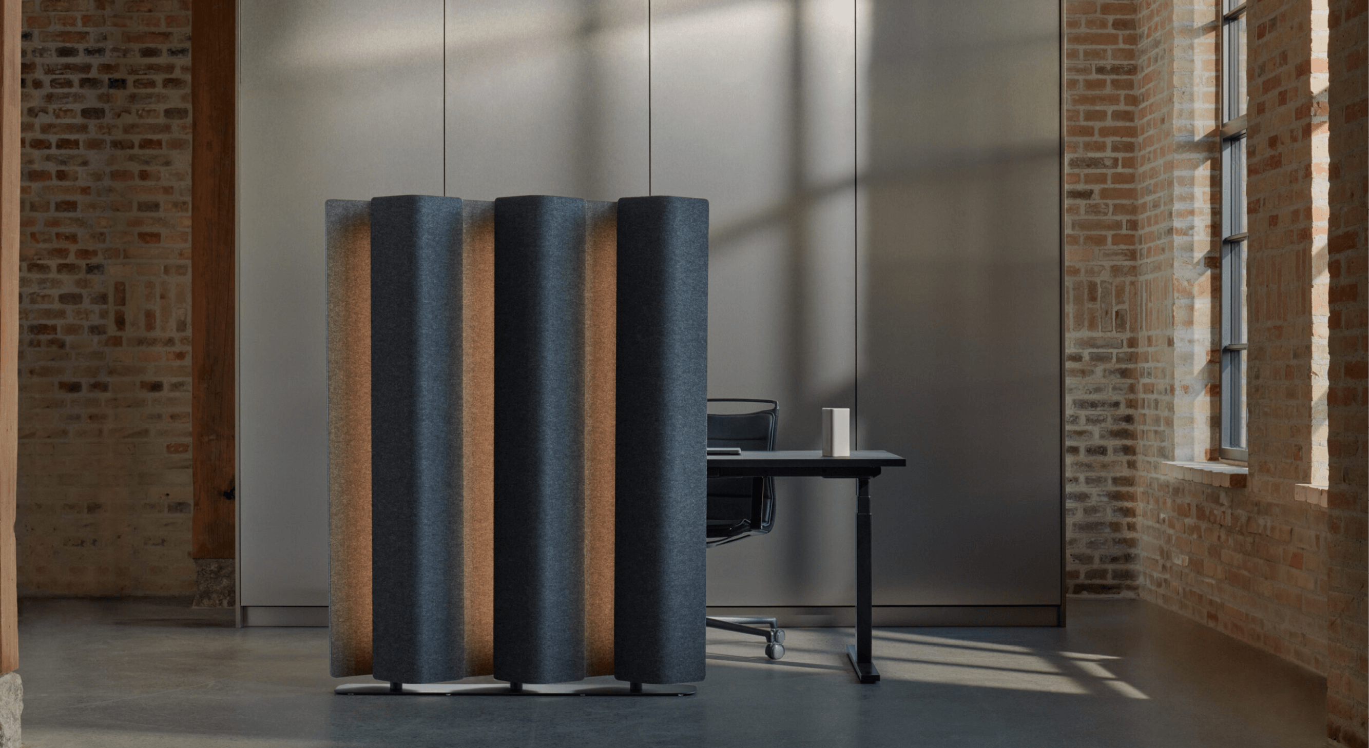 lighted acoustic floor screen in dark blue fabric covering in brick room